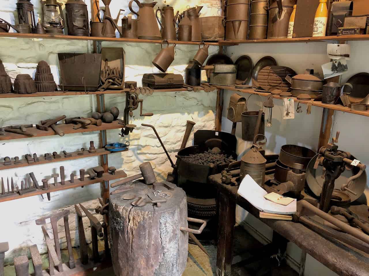 The Tinsmith's Shop at Ryedale Folk Museum, filled with sheets of tin, specialist shears, and soldering irons that reflect a time when everyday household items such as buckets, watering cans, and candle holders were carefully repaired rather than replaced.