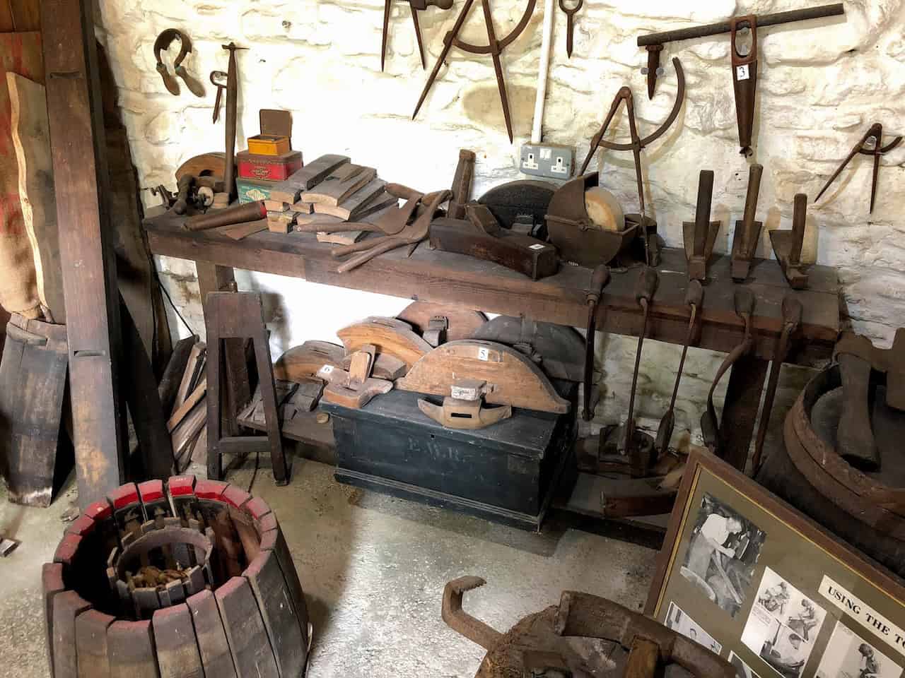 The Cooper's Shop, where the tools and techniques used to shape wooden staves and assemble watertight barrels and casks are on display, reflecting the vital role the cooper played in rural trade and storage.