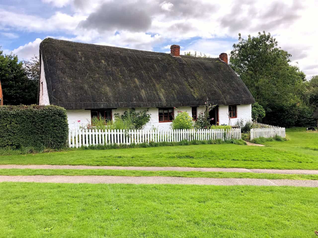 White Cottage, a Victorian cruck-framed cottage from Harome that served as a labouring family's home, featuring a working kitchen range still used for baking demonstrations and a traditional cottage garden.