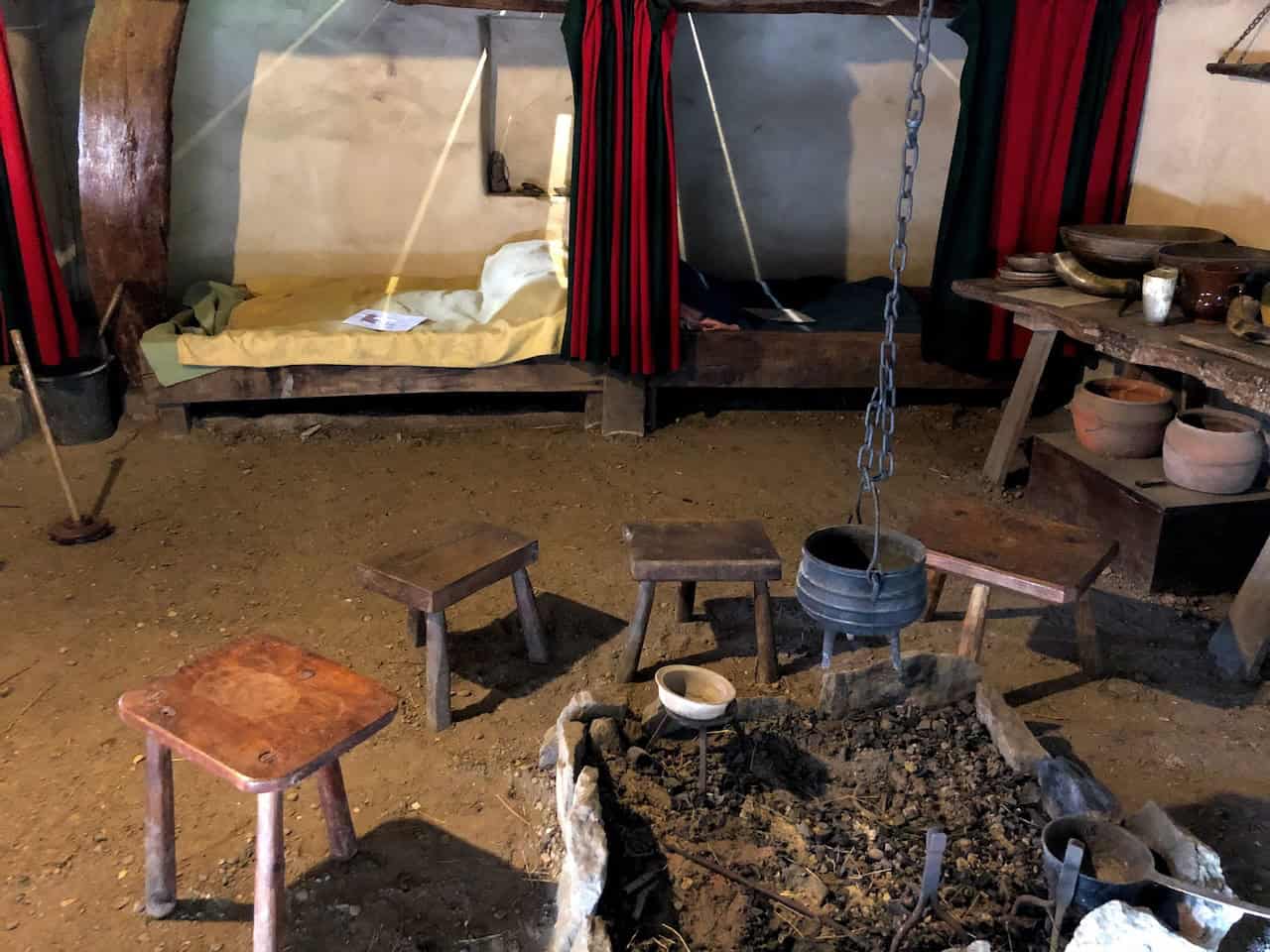 Inside the Medieval Crofter's Cottage at Ryedale Folk Museum, illustrating the cramped conditions of rural peasant life between the 13th and 16th centuries, with humans and animals sharing the same timber-framed structure.