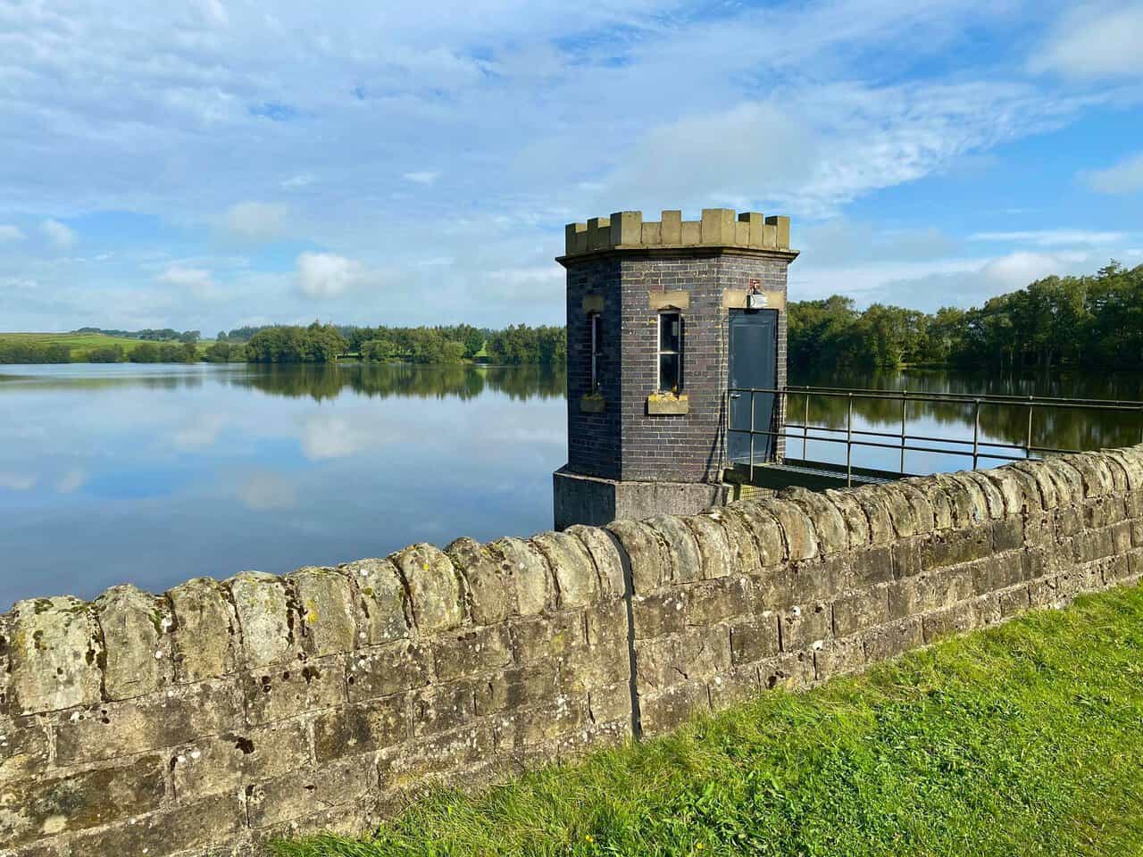 The control tower at Lumley Moor Reservoir standing beside the water.