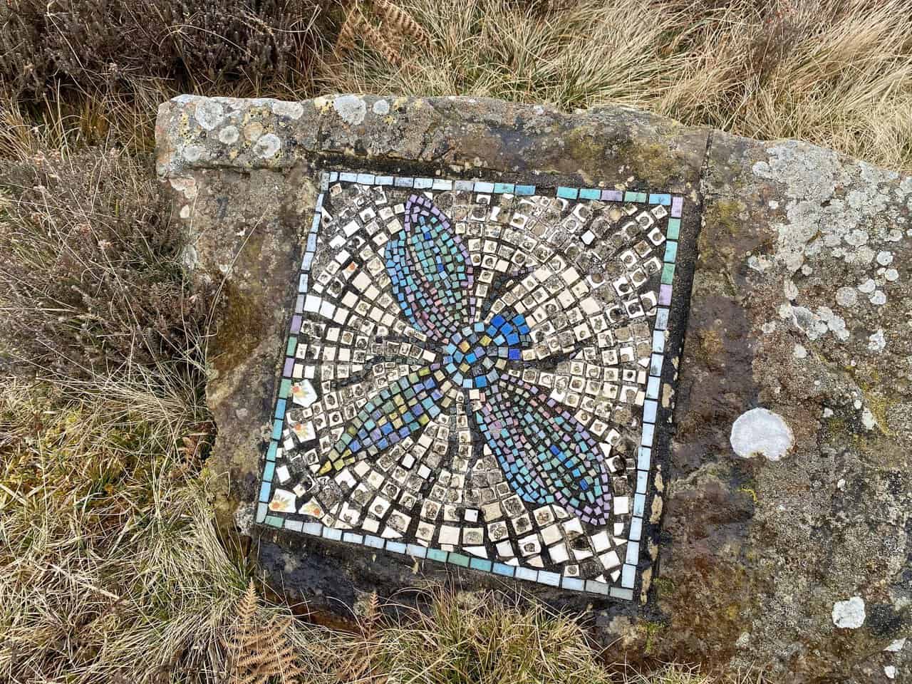 The Dragonfly mosaic beside a track near a sheep pen on Kirkby Malzeard Moor.