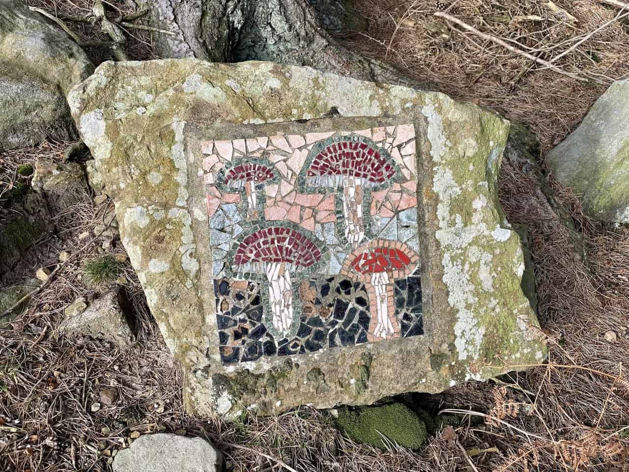 The Fungi mosaic appears beside woodland on the Crackpots Mosaic Walk.