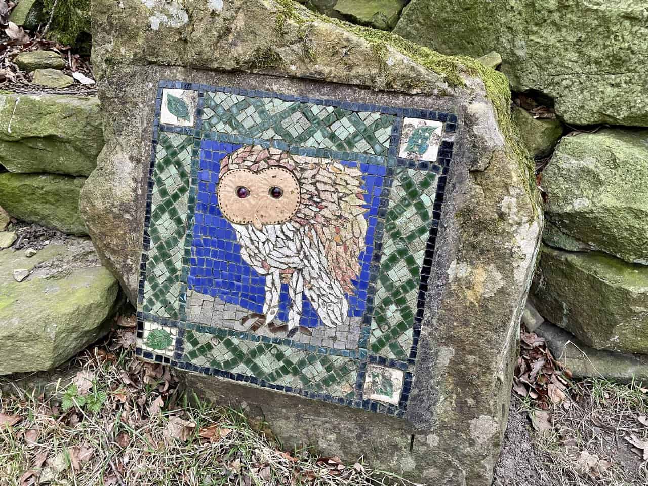 The Barn Owl mosaic is tucked away in woodland on the Crackpots Mosaic Walk.