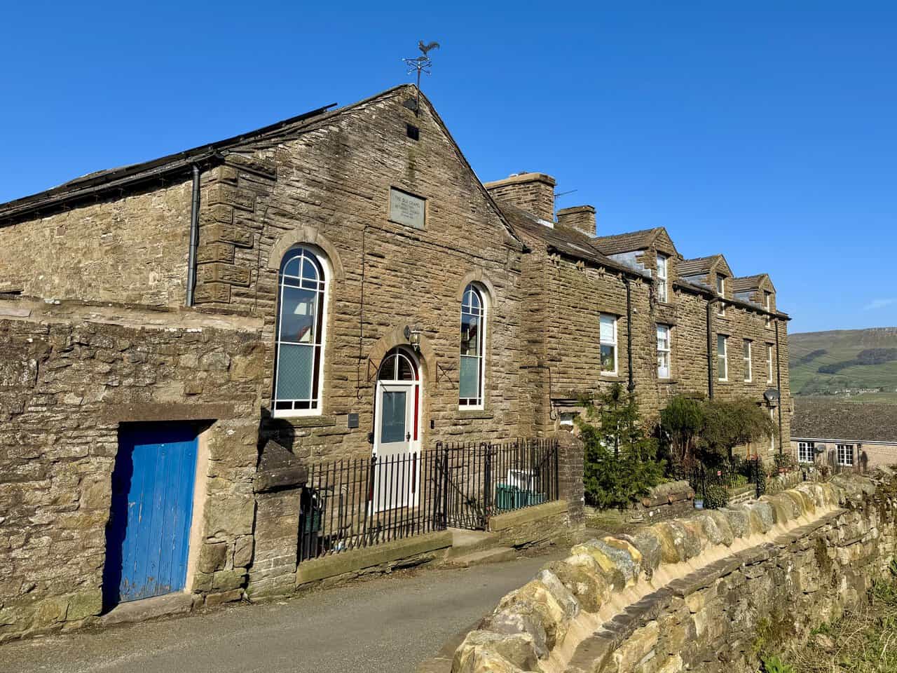 Traditional stone cottages and the old chapel in Burtersett, one of the villages visited on the Hawes Mosaic Trail.