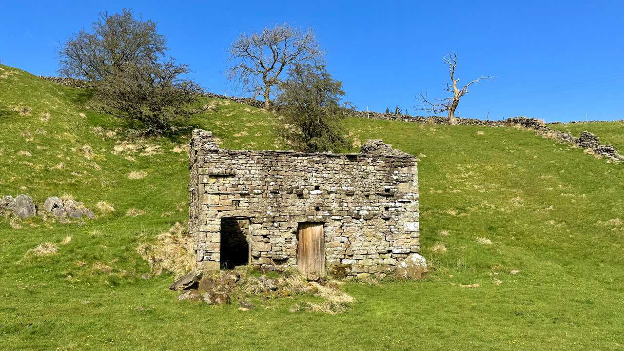 Old stone barns beside the path on the way to Aysgill Force on the Hawes Mosaic Trail.