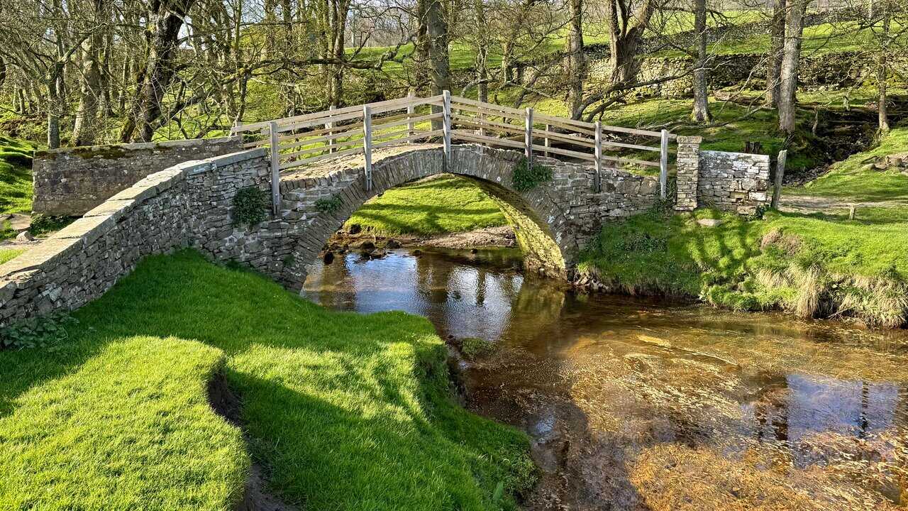 Crossing the old single-arched bridge on the return towards Hawes, with the stream flowing below.