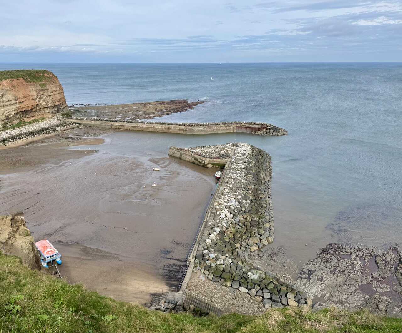 Staithes Harbour sits between steep hills and old fishing cottages.