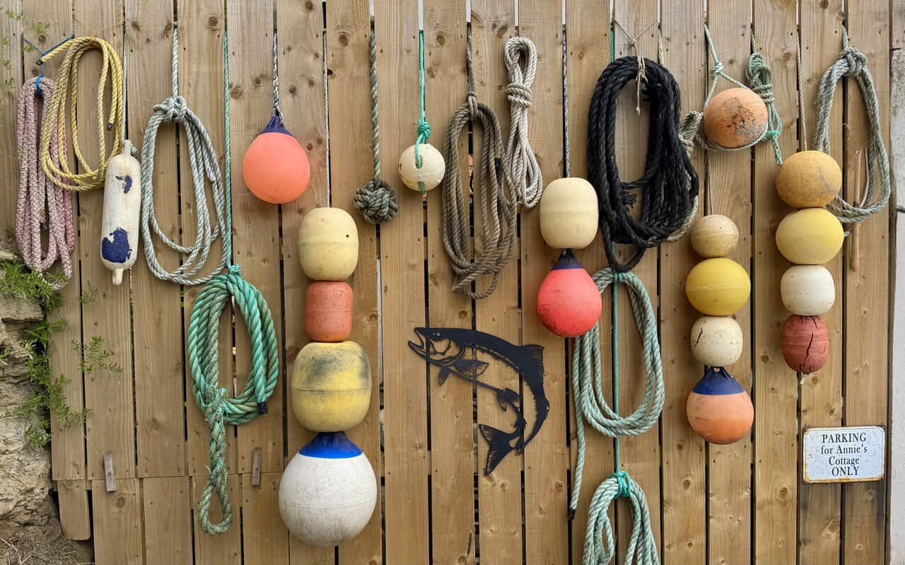 Bright buoys and fishing gear sit outside the lifeboat station at Staithes.