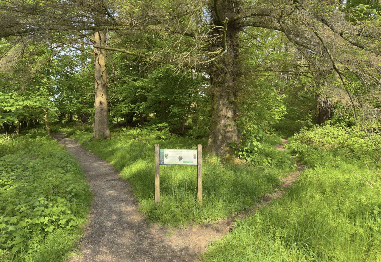 Interpretation board welcoming walkers to Grassington Park Estate Meadows, a Site of Special Scientific Interest in the Yorkshire Dales.