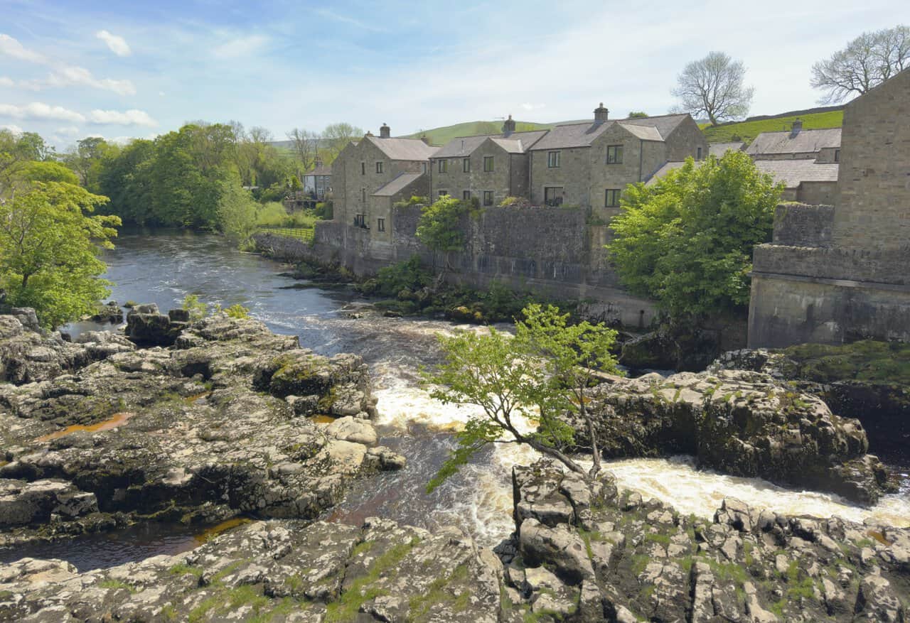 The River Wharfe tumbling through channels in the limestone bedrock at Linton Falls near Grassington, seen on the Hebden walk.