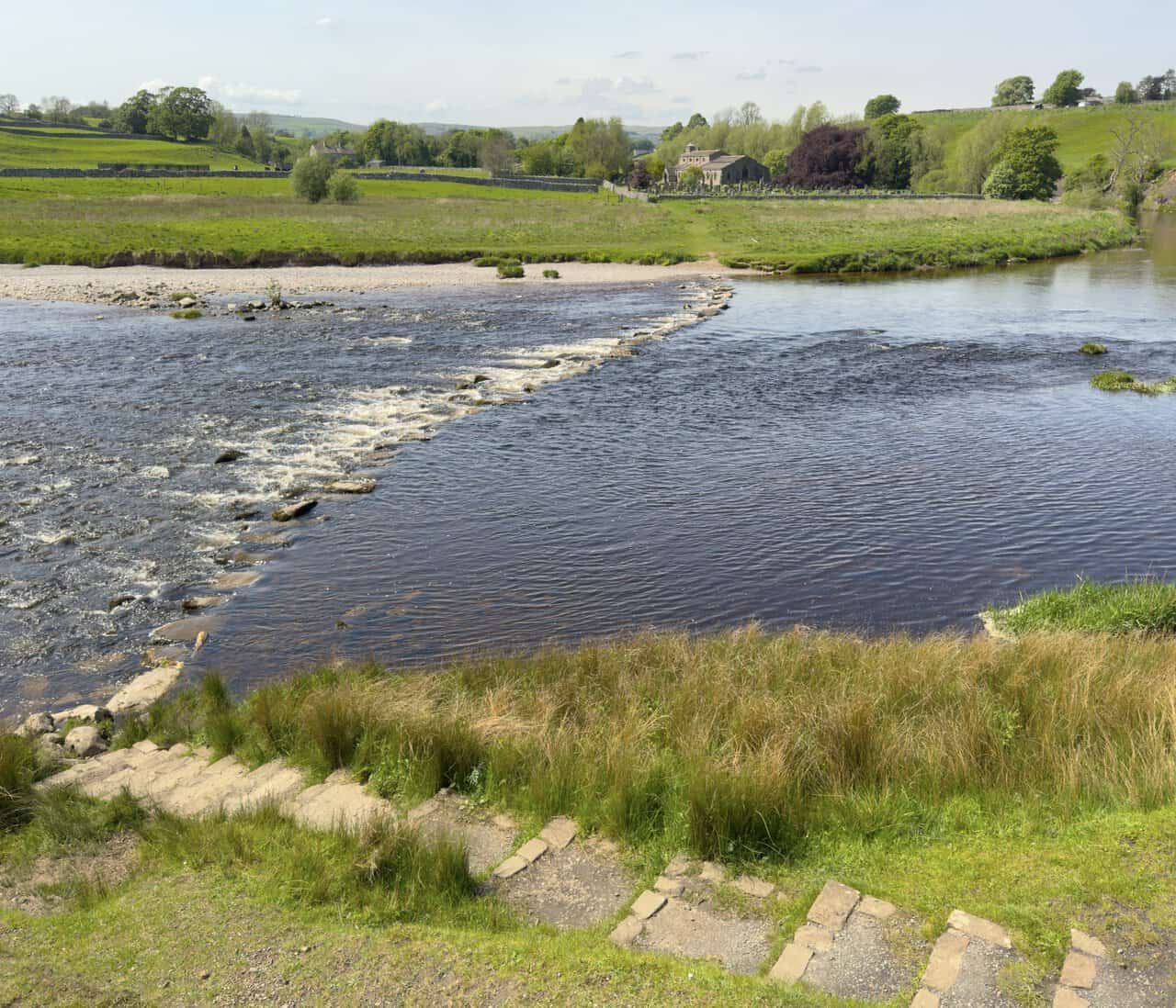 Stepping stones across the River Wharfe near Linton Church, seen from the junction on the Dales Way on this Hebden walk.
