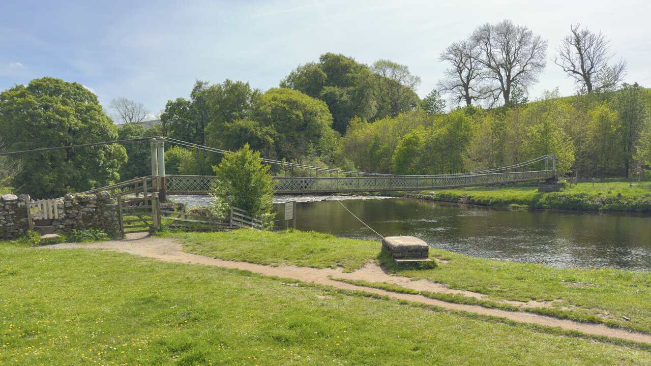 Hebden Suspension Bridge across the River Wharfe, built in 1885 by local blacksmith William Bell.