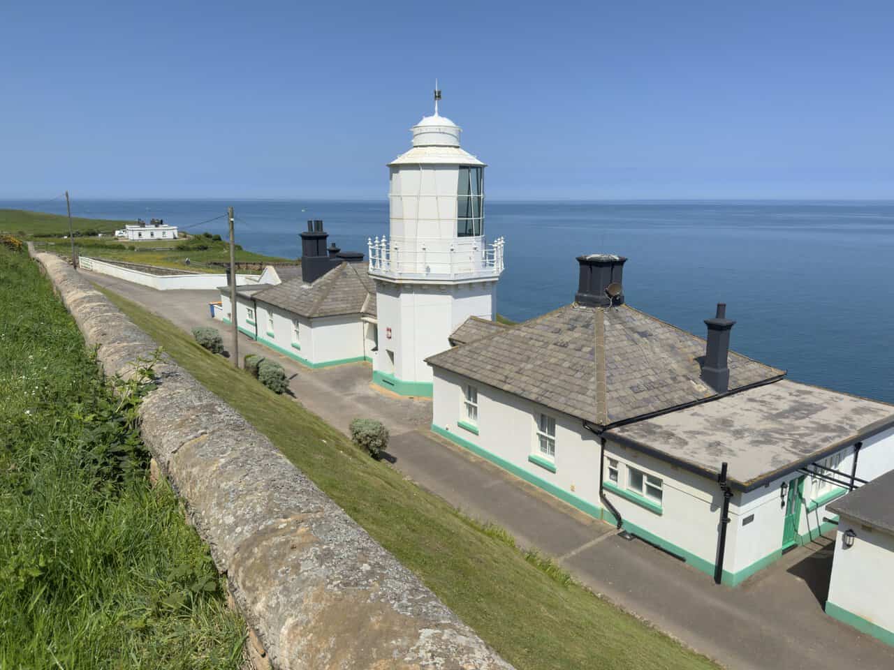 Whitby Lighthouse and its cottages sit high above the cliffs, with the tower looking out across the North Sea.