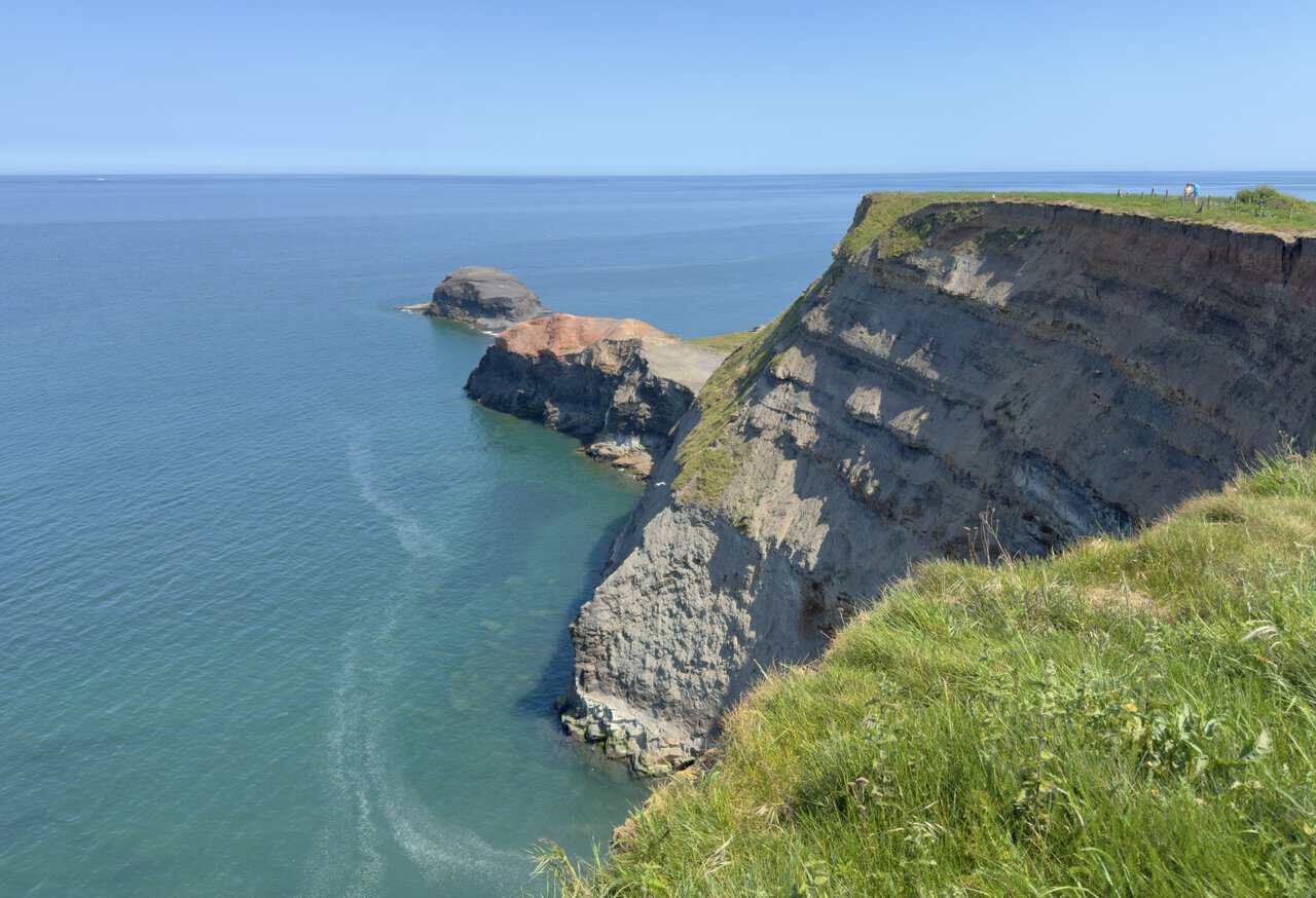 Saltwick Nab reaches into the sea below the coastal path, a rugged headland shaped by former alum quarrying.