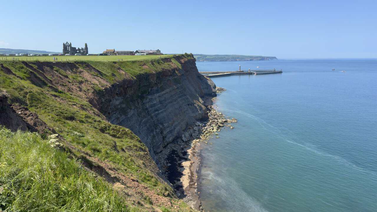 The Whitby walk gives a clear view of the piers and harbour entrance, with Whitby Abbey standing on the clifftop ahead.