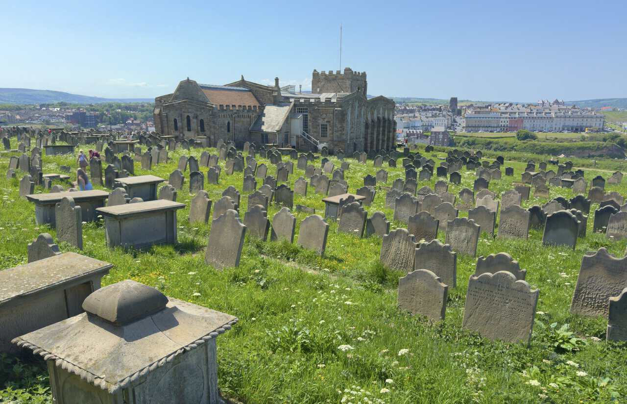 St Mary's Church stands above the Whitby walk, with its stone tower, crowded churchyard and wide views over the town.