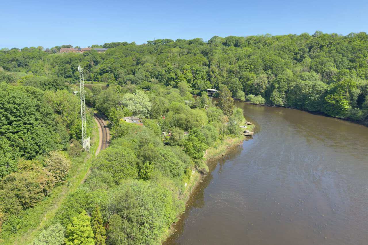 The Whitby walk crosses Larpool Viaduct, where the River Esk winds below and the railway follows the wooded bank.