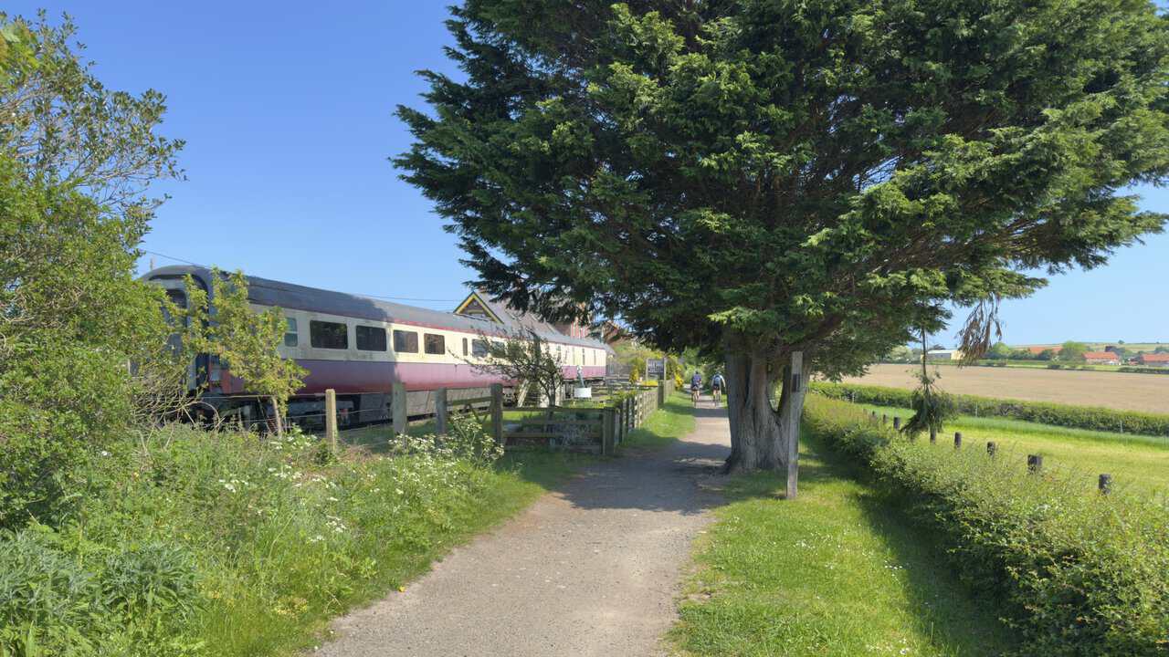 Former railway carriages stand beside the Cinder Track at Hawsker, where the old station has been given a new use.