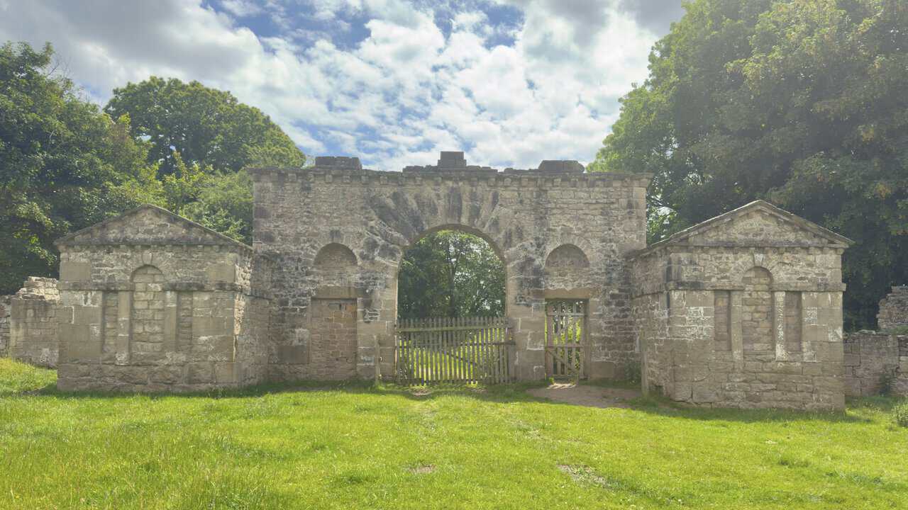 Mackershaw Lodge on a Ripon walk, a ruined eighteenth-century arched stone gateway with flanking roofless lodges.
