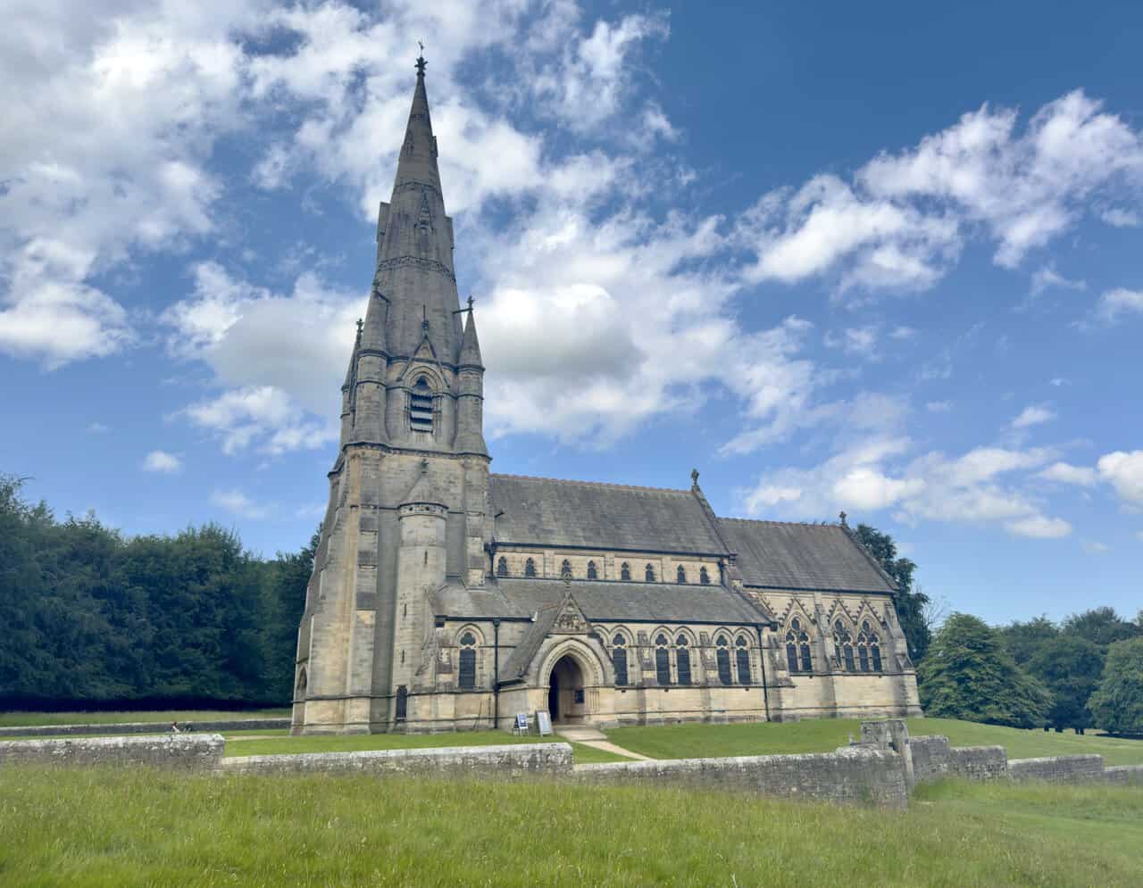 St Mary’s Church, Studley Royal, showing the long nave, steep roofs and richly detailed Gothic architecture.