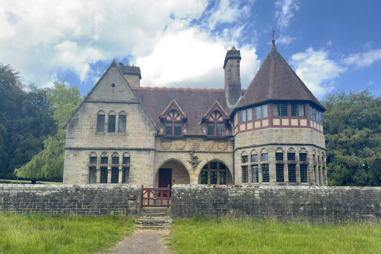 The carved porch and decorative details of Choristers’ House, including shields and a stag above the entrance.