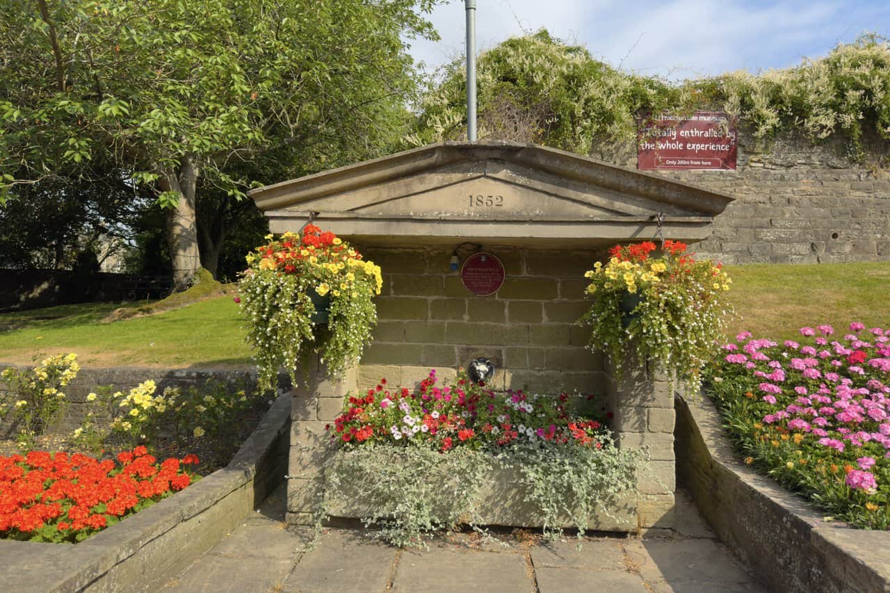 Fox’s Head Well on the Brimham Rocks walk, featuring a stone pediment and small fox-head spout.