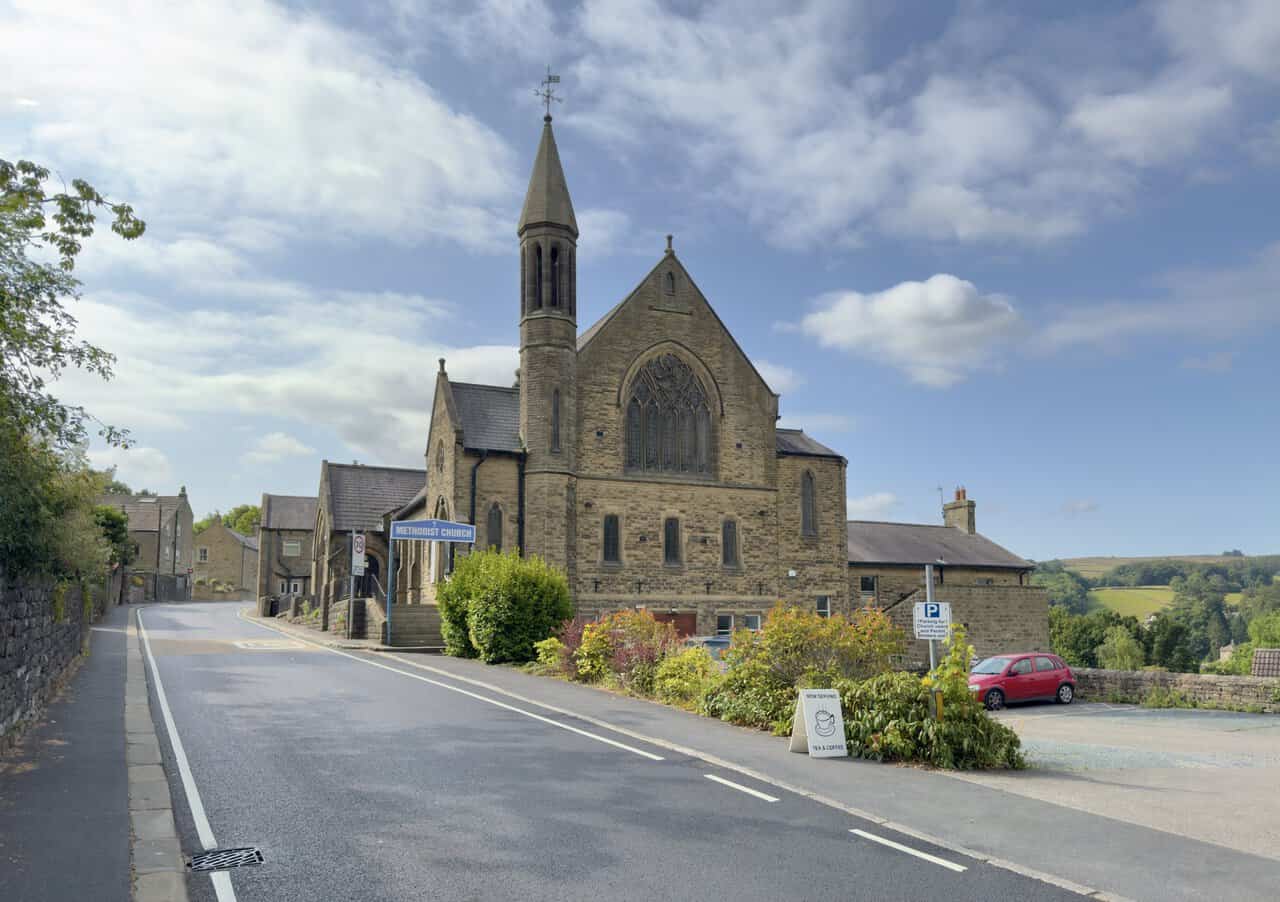 Pateley Bridge Methodist Church beside Ripon Road, with its slender spire and tall traceried window.