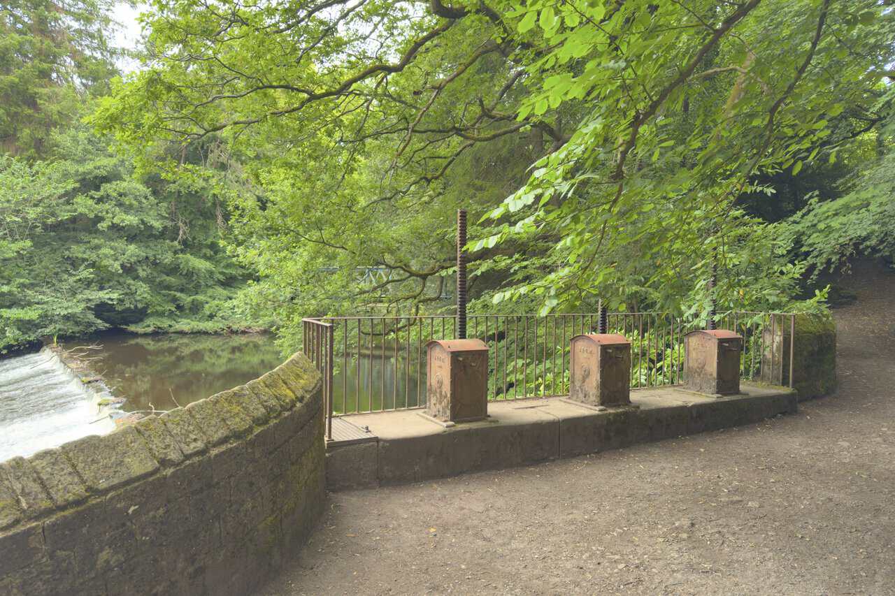 Three cast-iron sluice mechanisms beside the River Nidd weir near Glasshouses.