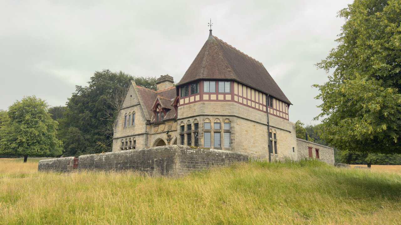 Chorister's House, showing its octagonal turret, conical roof and decorative timber framing.