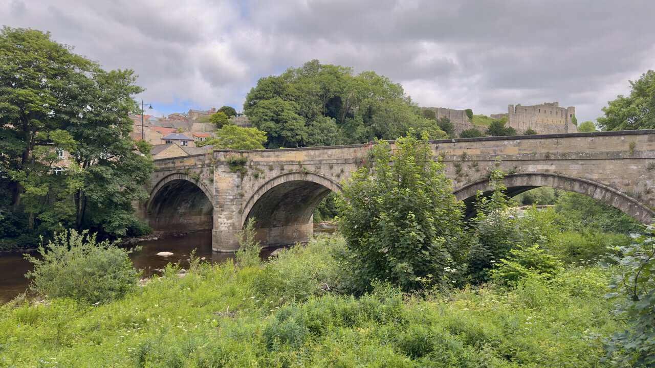 Green Bridge on the Richmond walk, a three-arched stone bridge over the River Swale with Richmond Castle beyond.