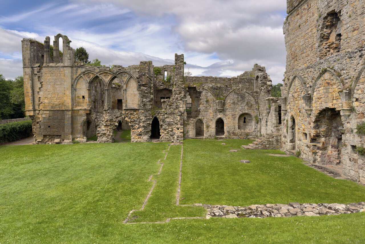Roofless ruins of Easby Abbey on the Richmond walk, with grassy foundations and atmospheric stone walls beside the Swale.