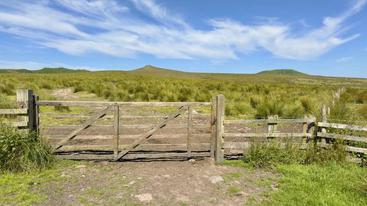 Wooden gate on the Dales High Way opening onto the open fell, with Sharp Haw ahead and Rough Haw right.
