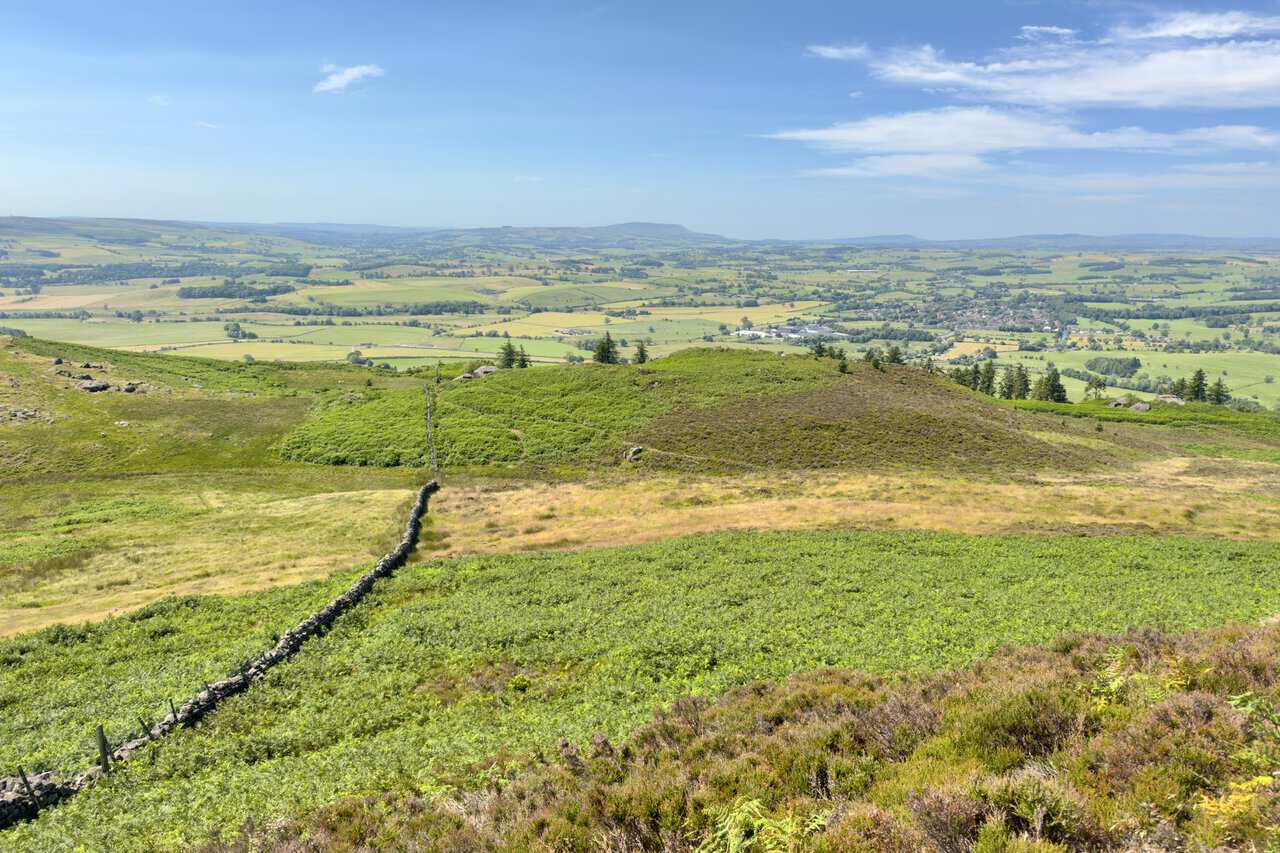 View south-west from Sharp Haw over Gargrave and its fields, with Pendle Hill on the far horizon.