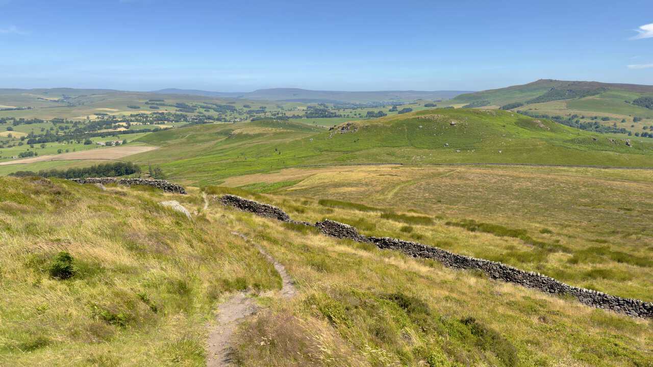 Narrow path dropping from Sharp Haw through rough grass to a dry stone wall, with Rough Haw ahead.