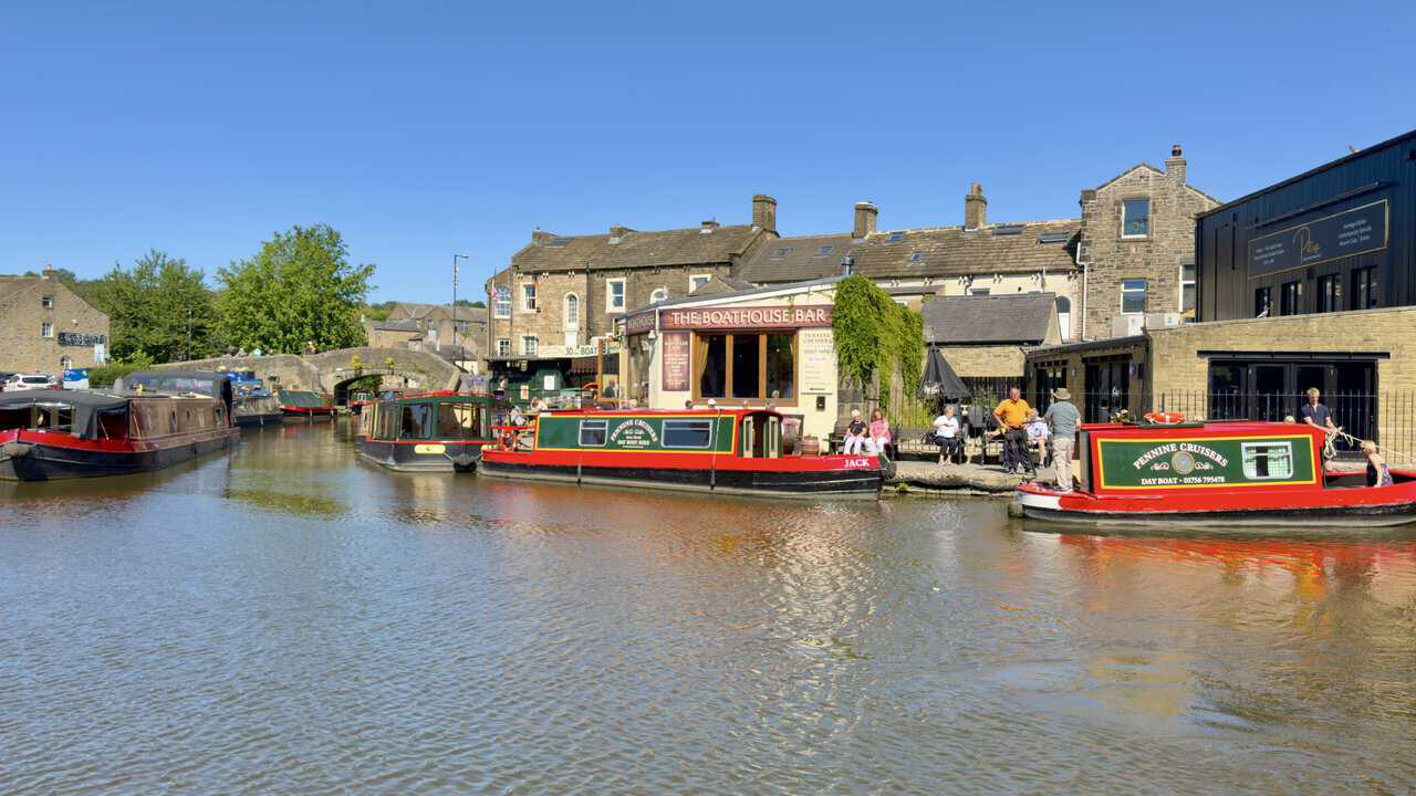 Narrowboats and the Boathouse Bar at the canal basin in the centre of Skipton.
