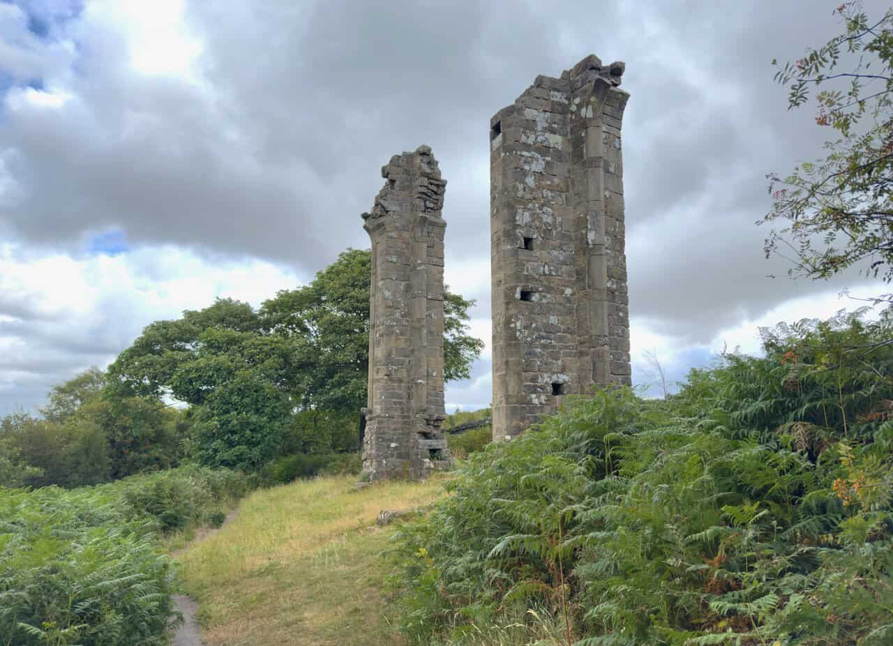 The twin stone pillars of Yorke's Folly, the landmark that gives the Yorke's Folly walk its name, rising above the bracken.