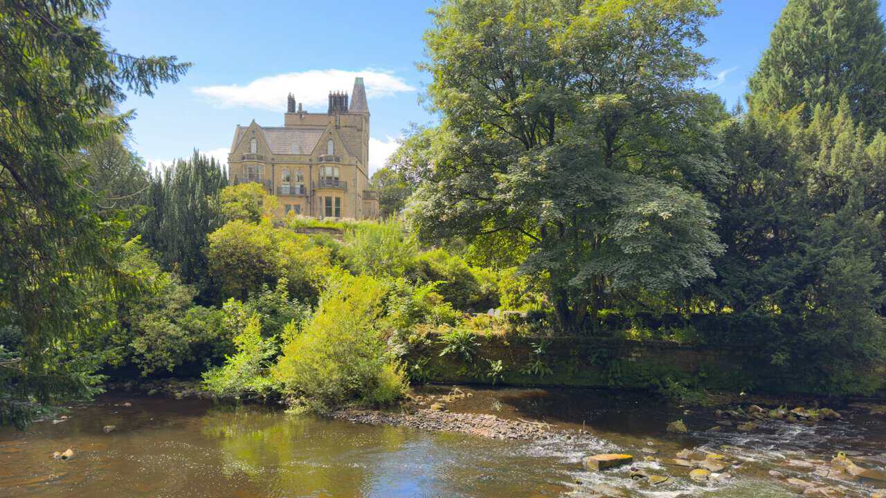 Castlestead on the Yorke's Folly walk, a grand turreted house set among trees above the River Nidd.