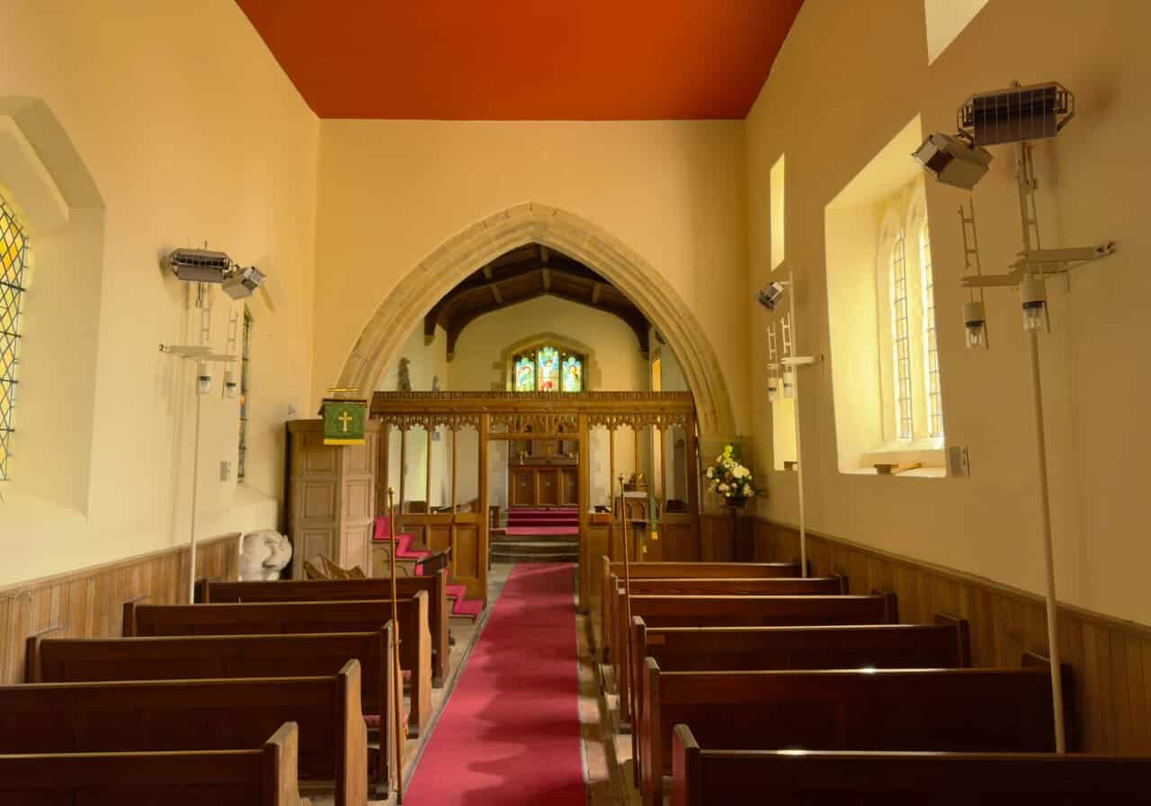 Looking east along the nave of St Martin's Church towards the carved screen and chancel arch.