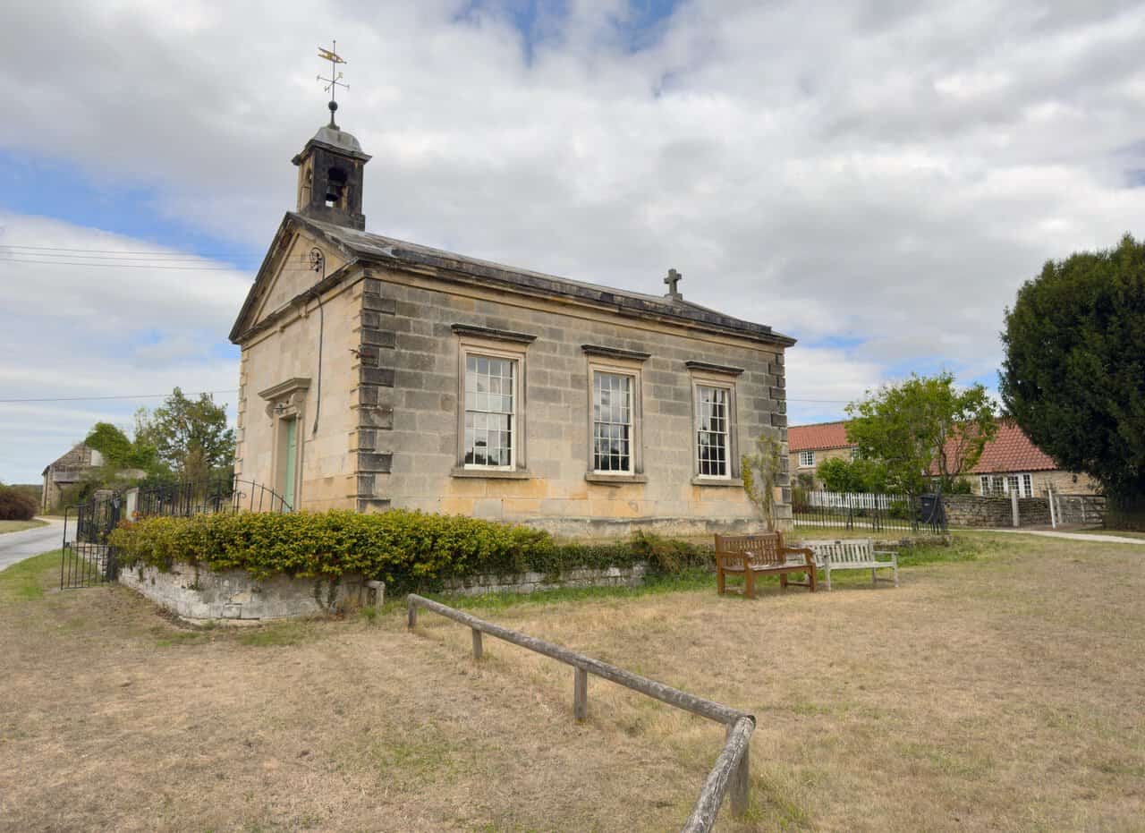 Coneysthorpe Chapel, a Georgian limestone building with a domed bell turret and weathervane.