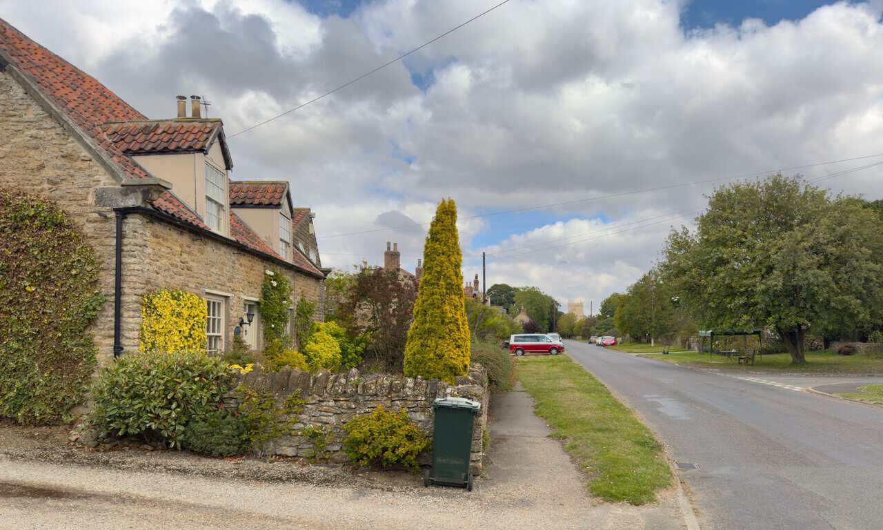 Stone cottages along the road in Bulmer at the end of the Castle Howard circular walk.