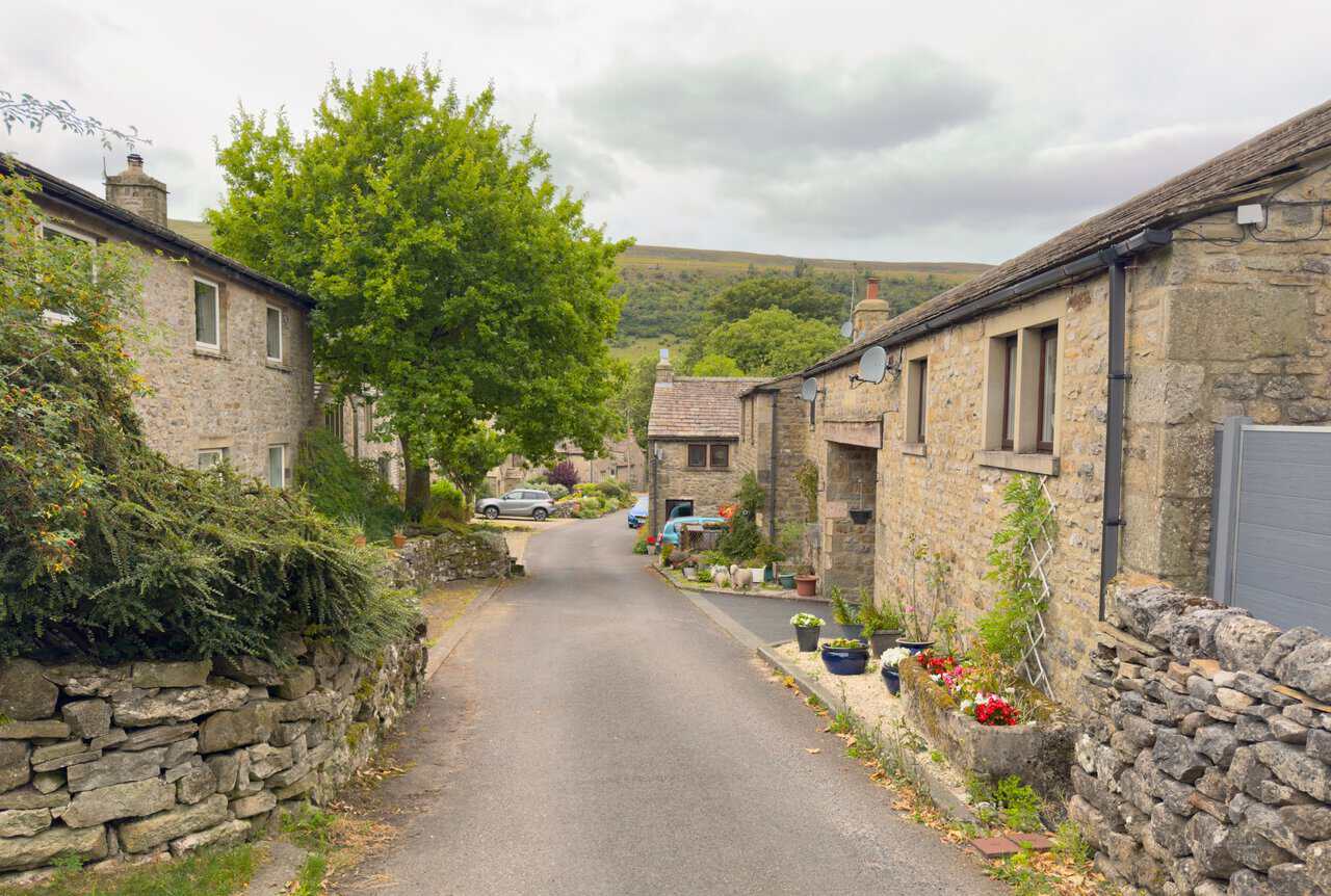 A quiet lane running between stone cottages in Starbotton on the Great Whernside circular walk.