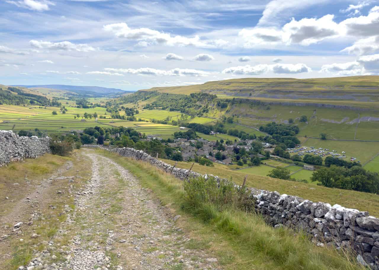 The stony track steepening towards Kettlewell on the final descent of the Great Whernside walk.