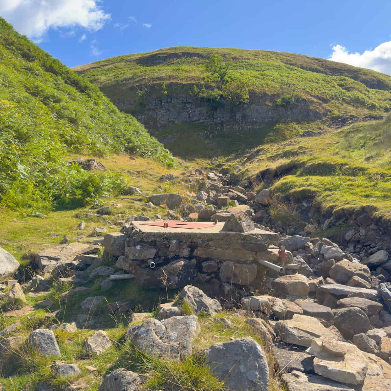 The capped entrance to Providence Pot, set among loose rock and backed by a low limestone scar on the shorter of my Great Whernside walks.