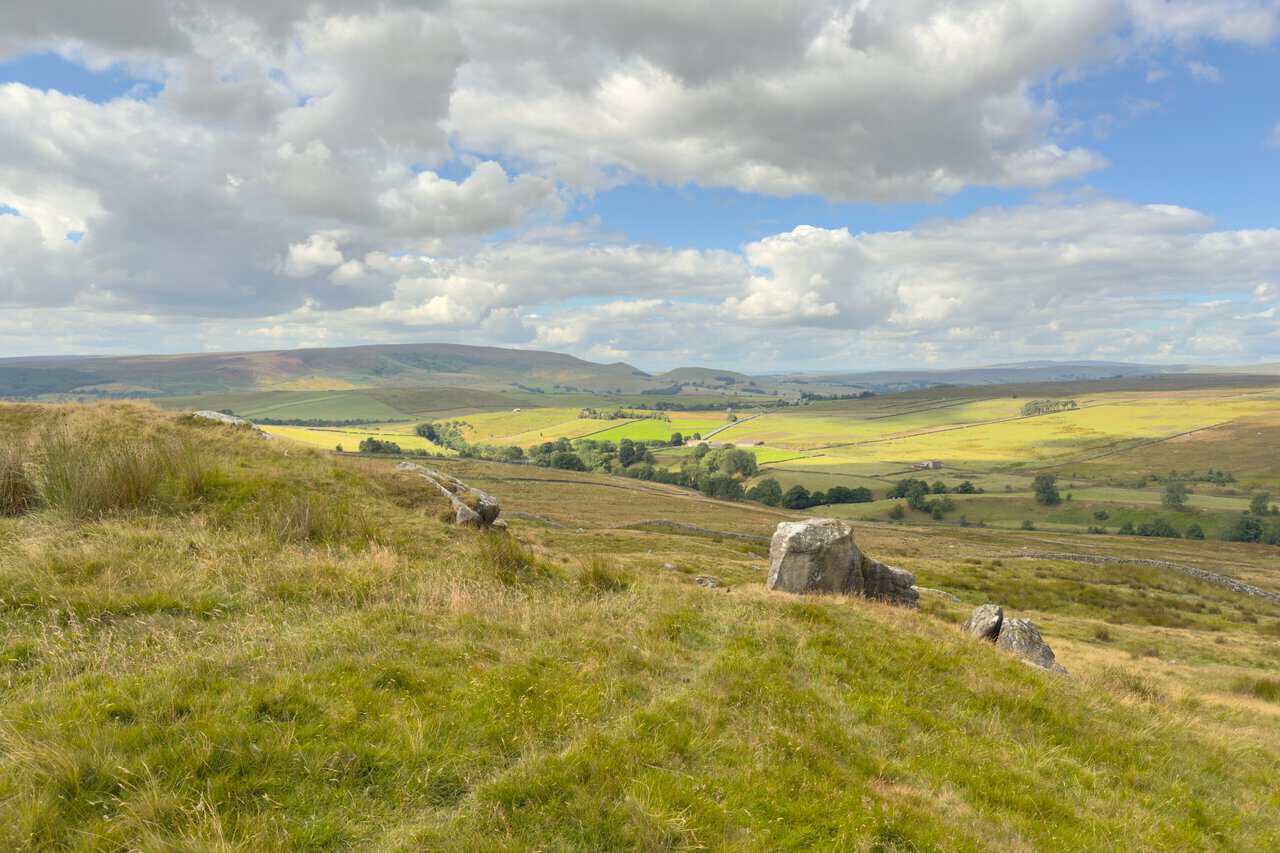 View south-west towards Burnsall and Thorpe Fell, with Stebden Hill and Elbolton above walled fields.