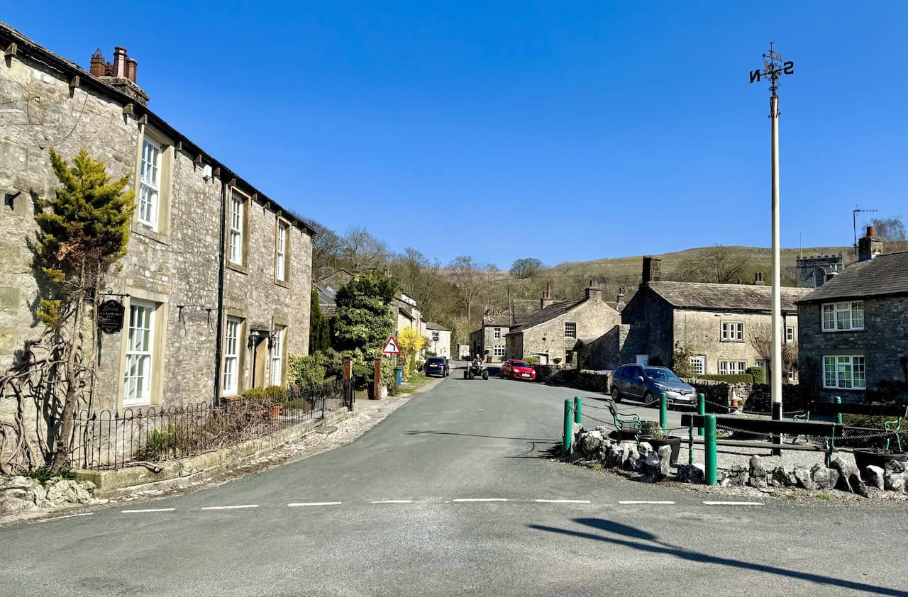 Stone cottages, a small green and the maypole in Kettlewell, the starting point of the Wharfedale 3 Peaks.
