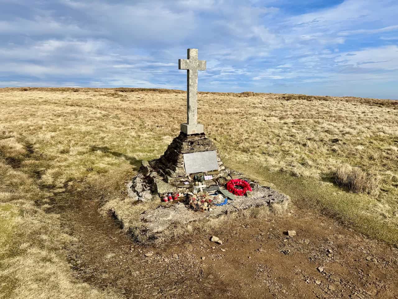 Poppy wreaths and candles at the foot of the Polish Airmen's Memorial cross, a moving stop on the Wharfedale 3 Peaks.