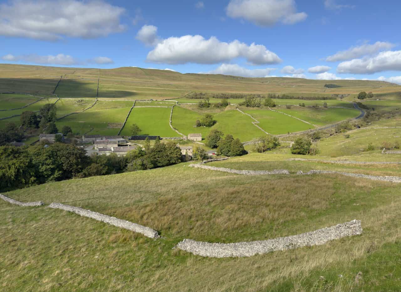 The hamlet of Cray among walled green fields, seen from Buckden Rake.