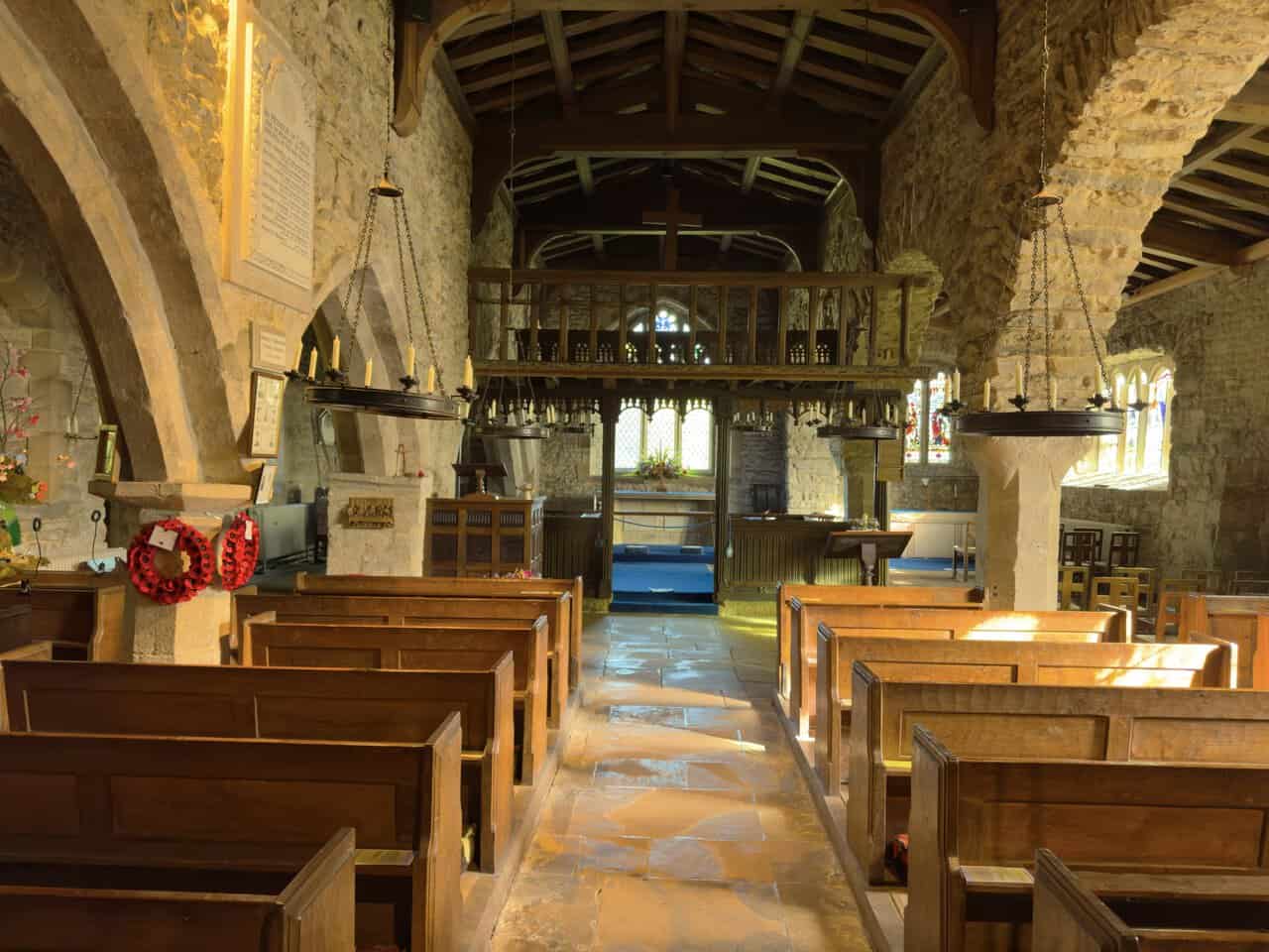 The nave of St Michael and All Angels Church, looking towards the painted wooden rood loft.