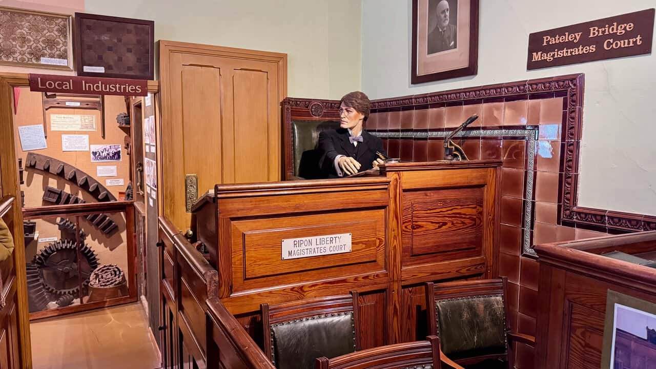 Figures of a magistrate and a clerk seated at the bench of the old Pateley Bridge courtroom.